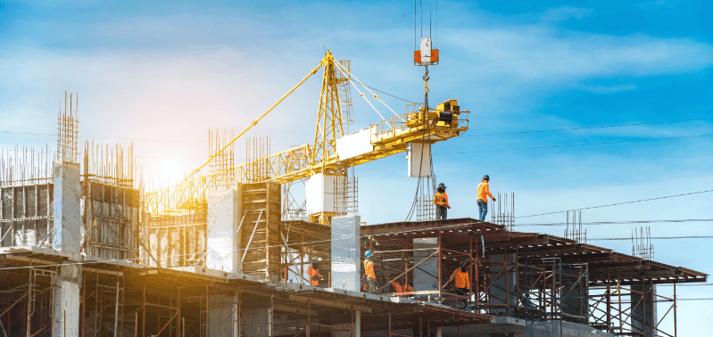 Team of construction workers at a site, employing real-time location technology to enhance workflow and safety.