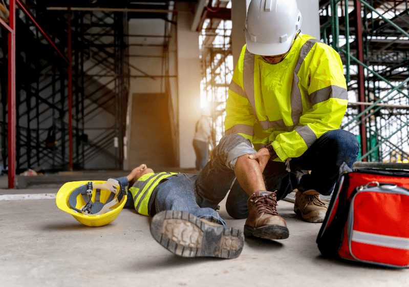 Image of an injured construction worker being inspected by another