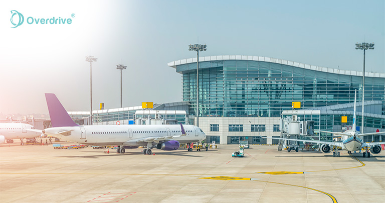 Airport terminal with aircraft showing IoT asset tracking infrastructure.