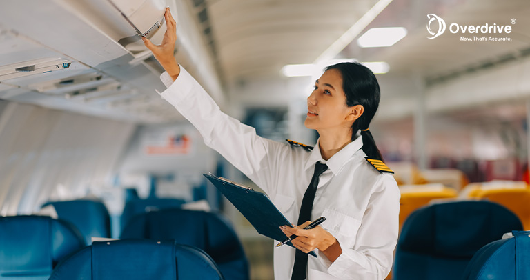 Flight attendant inspecting aircraft equipment with IoT tracking technology.