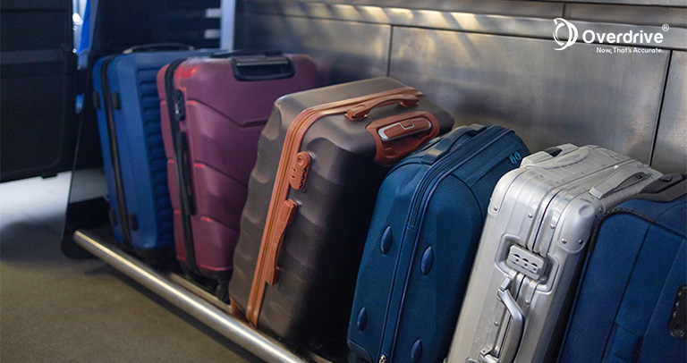 Row of luggage bags neatly stacked against a wall